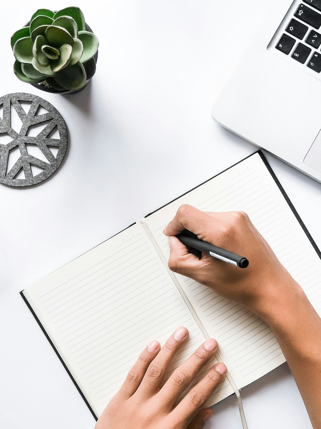person writing in journal