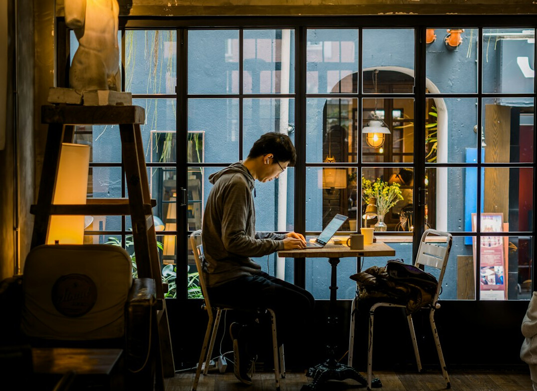 person journaling in cafe