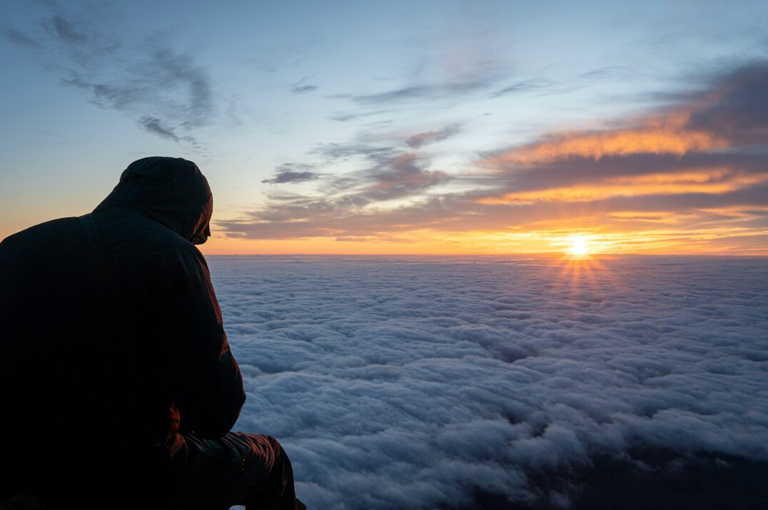 person journaling at sunrise